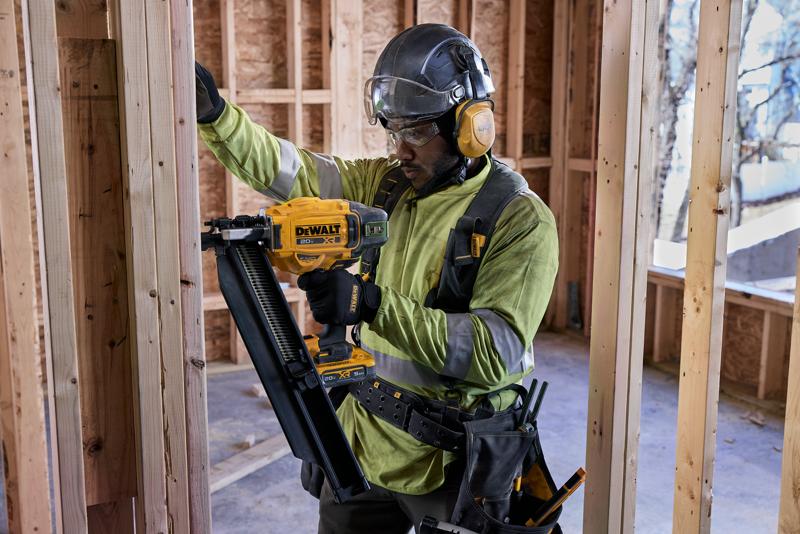 user working with nailer on commercial jobsite 