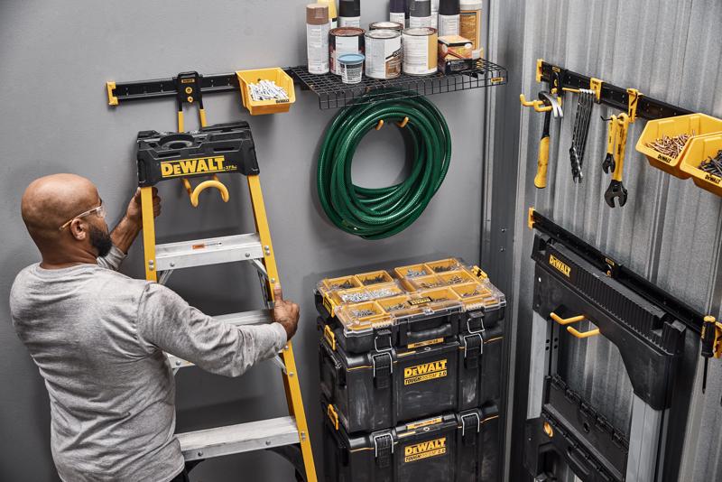 A Person Grabbing a Ladder off of a DEWALT Metal Rail Featuring Lawn/Garden Kits