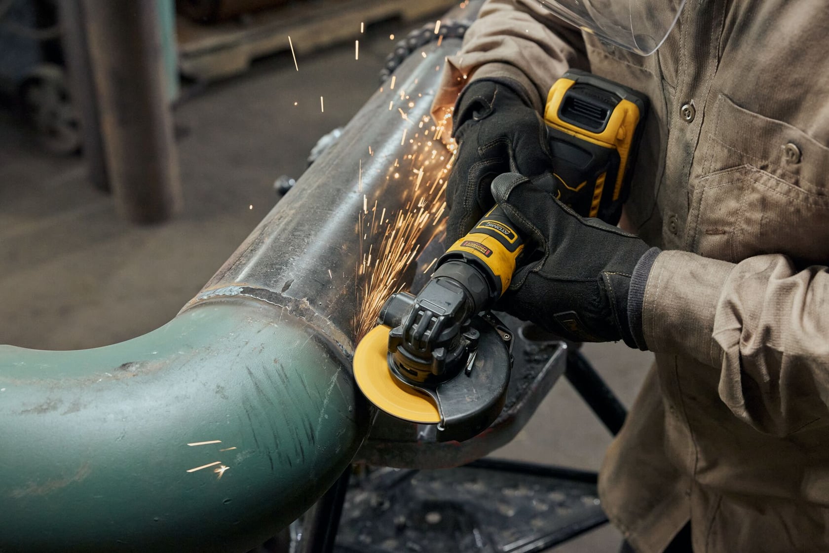 ATOMIC™ 20V MAX* 4 in. Angle Grinder completing pipe application