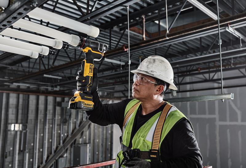 DEWALT PEX Expander is used to expand tubing by a tradesman on a lift in a mechancial room.